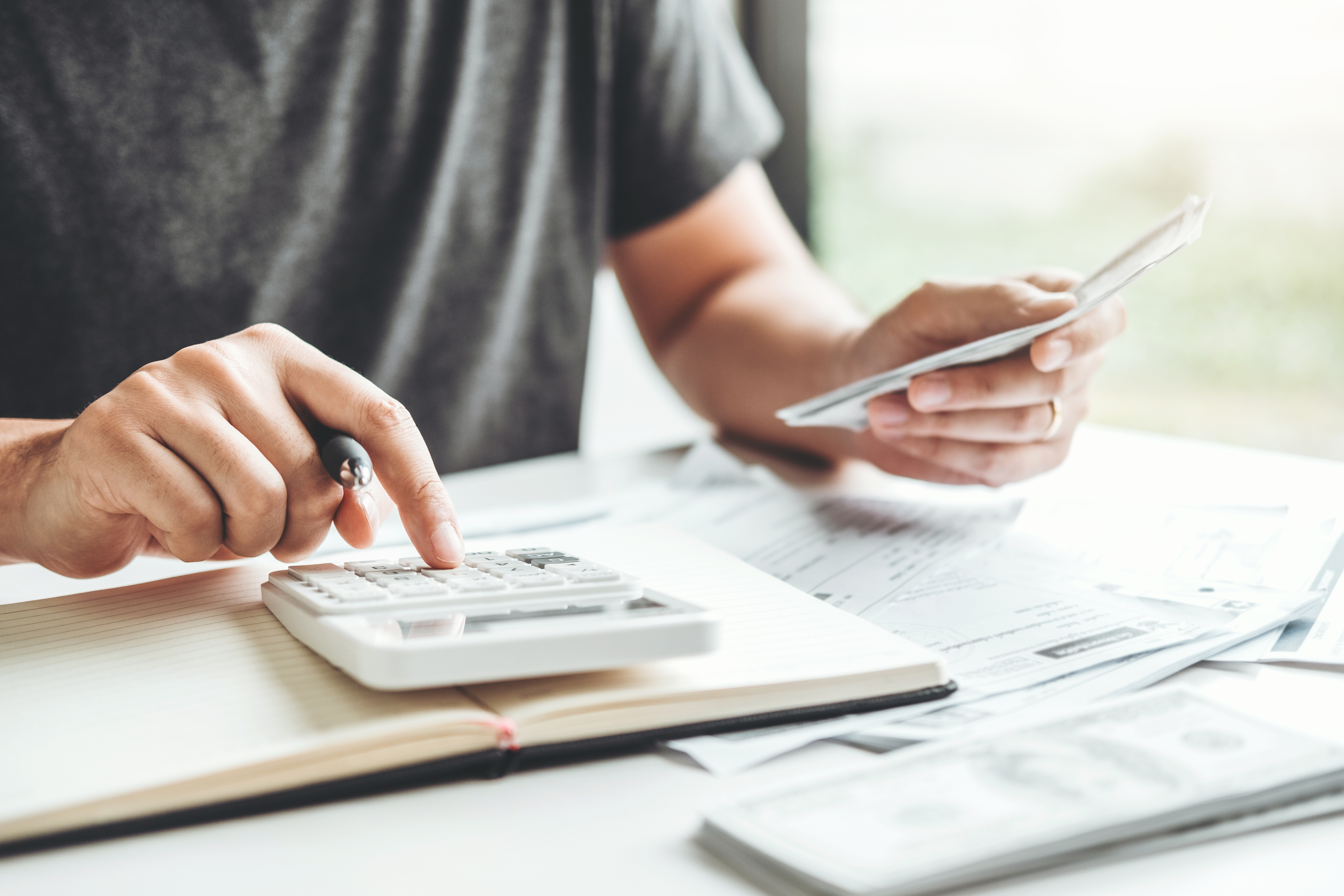 Person with calculator and papers