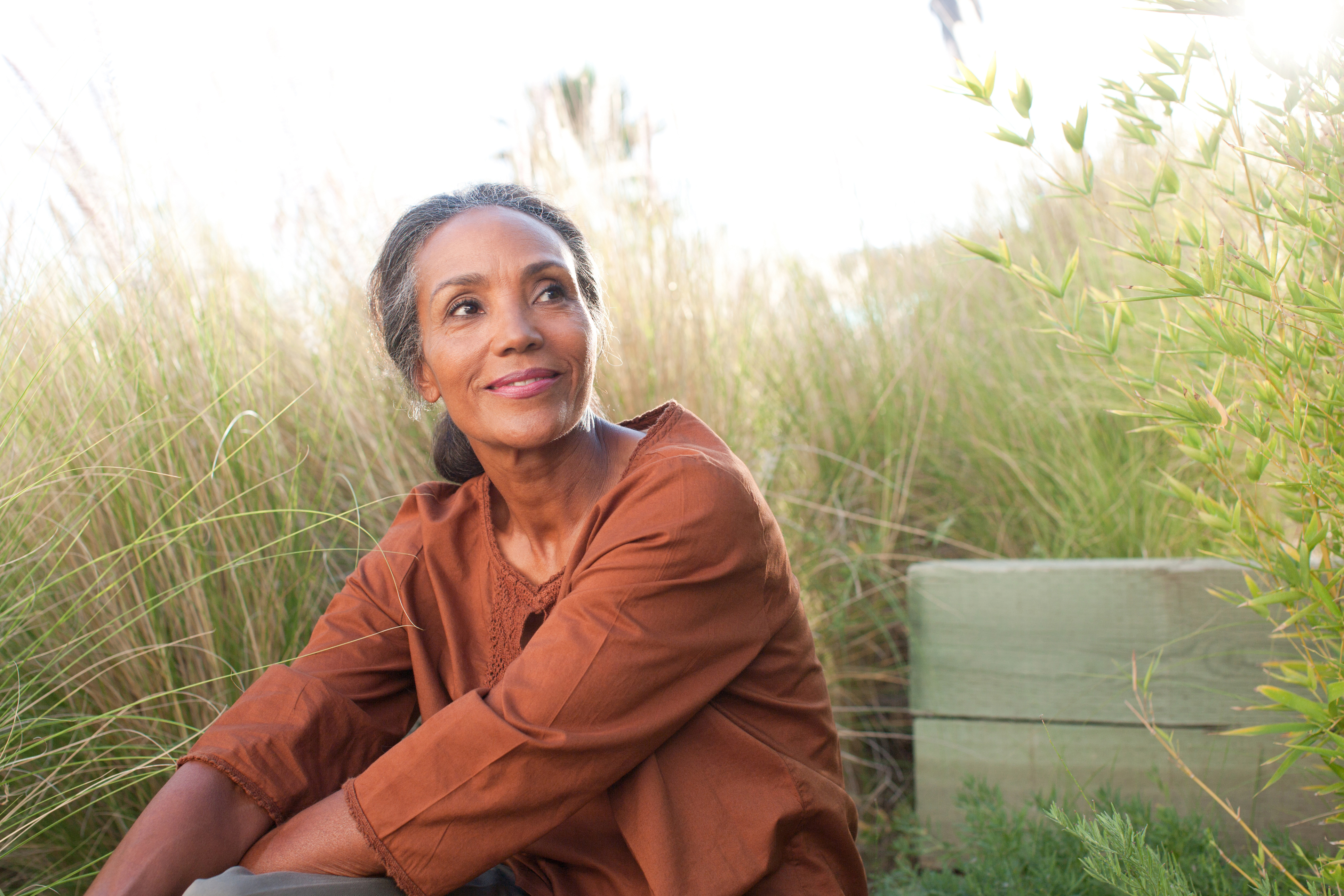 Older woman sitting on bench outside