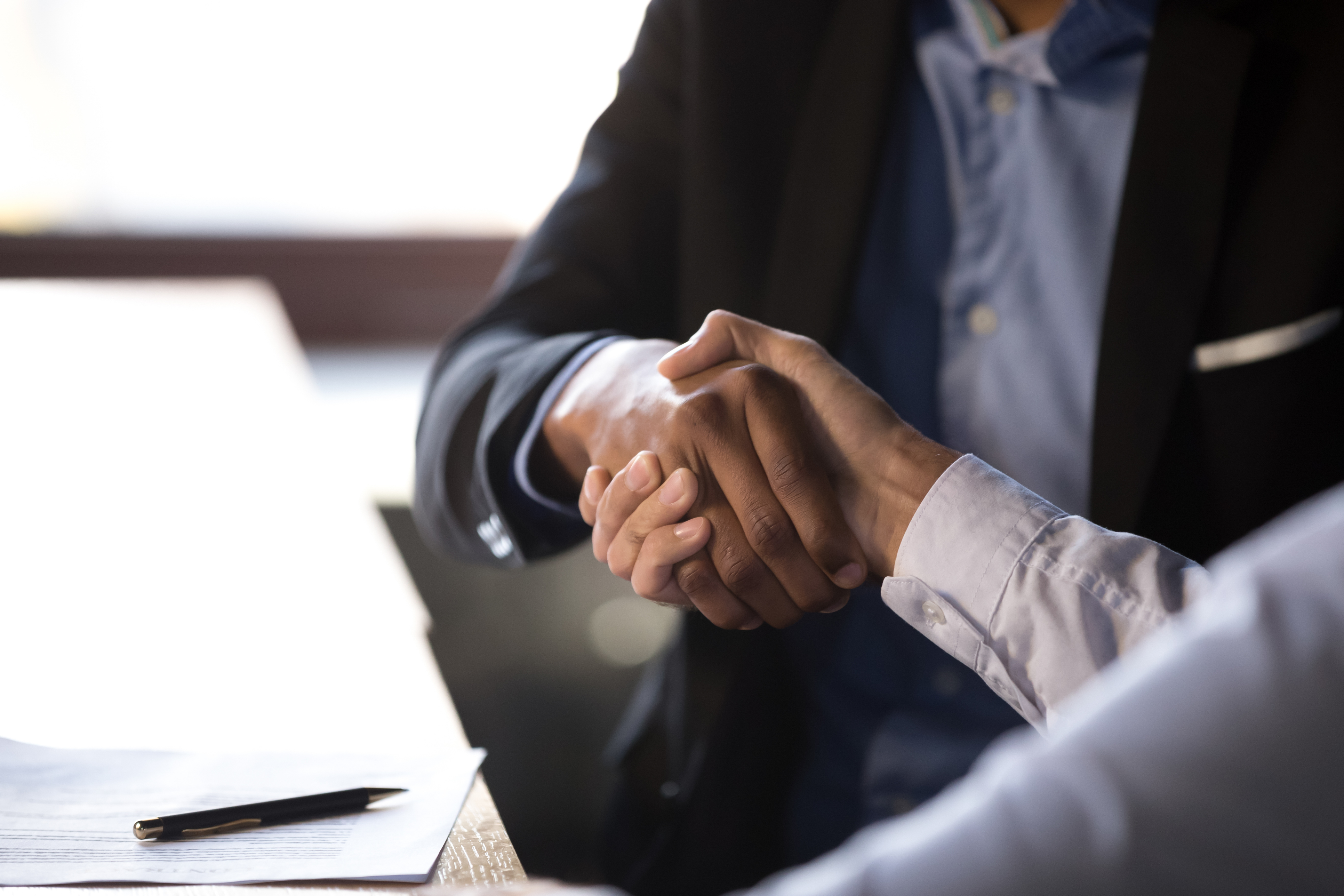 Two men at office shaking hands