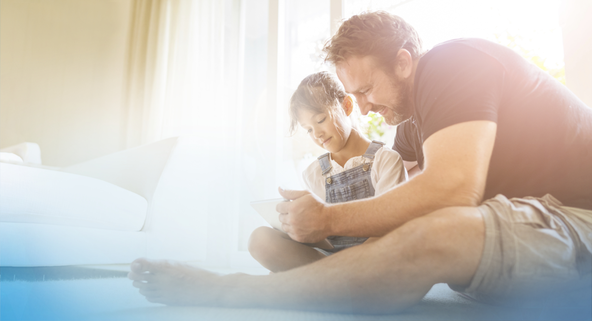 Father and daughter looking at tablet