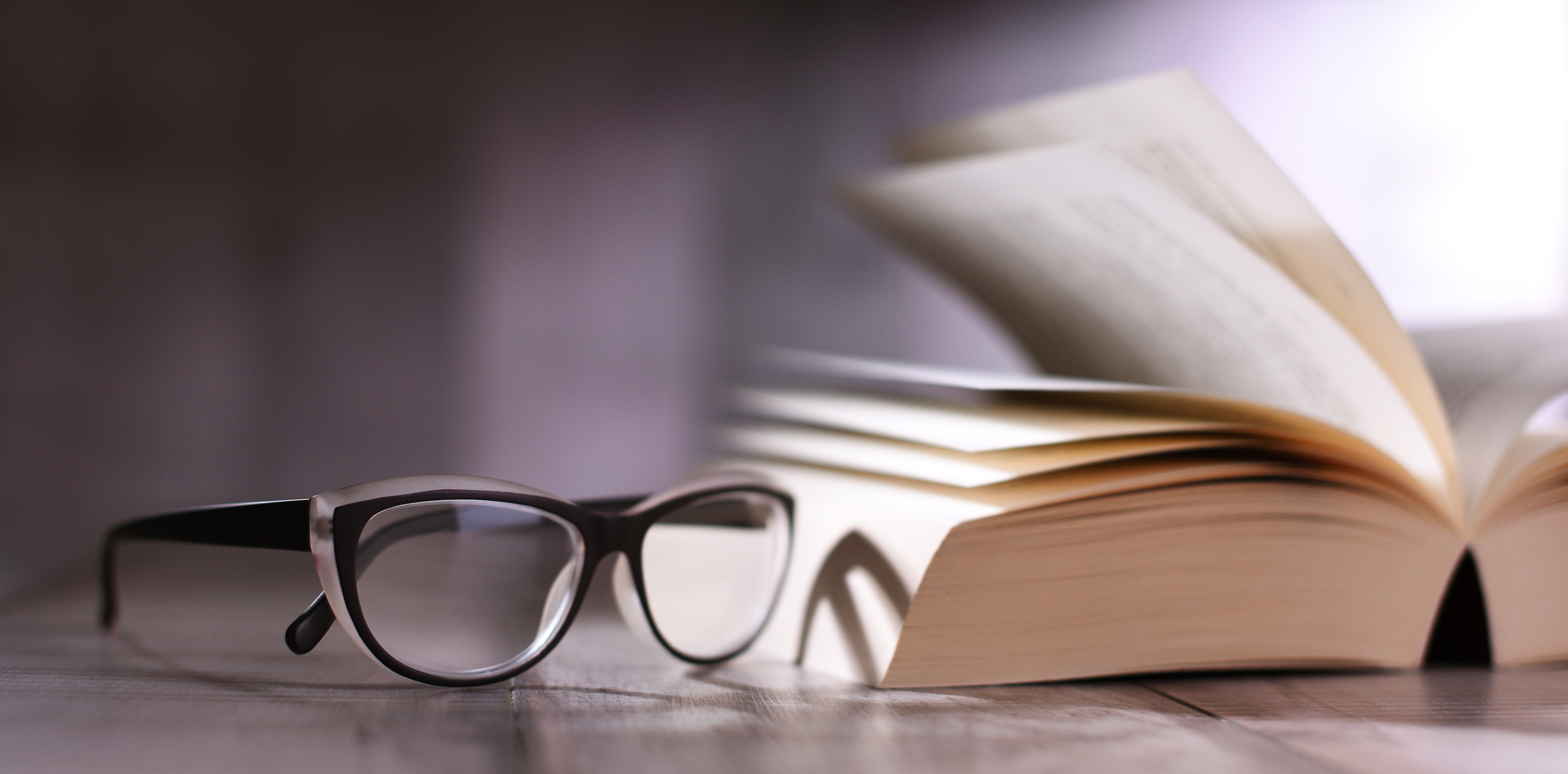 Glasses and dictionary on table